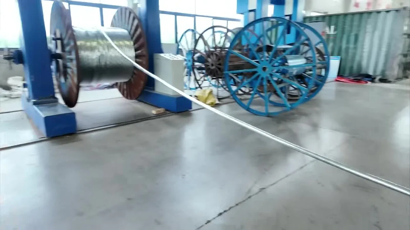 Sheathed medium voltage cable running through the cooling and take-up section of the extrusion line onto a factory drum