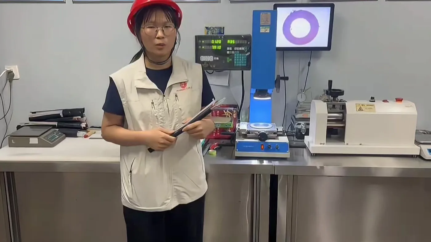 Projection measuring instrument in a cable factory test laboratory used to measure sheath and insulation wall thickness on a cut cable ring sample